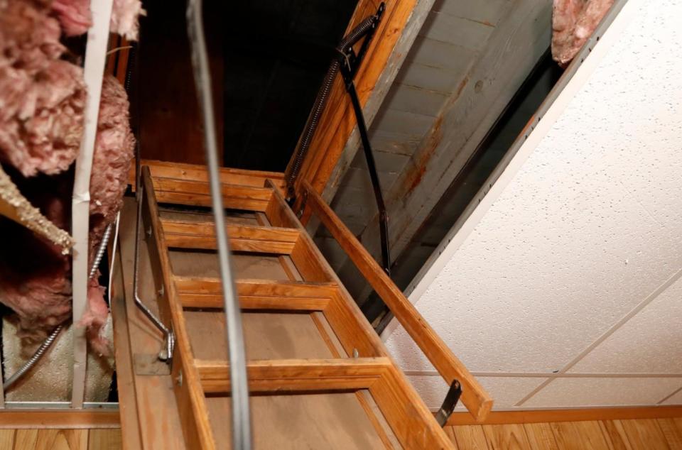 A small crawlspace near the top of the pull down ladder at the former funeral home - where Michigan inspectors found the remains. (AP)