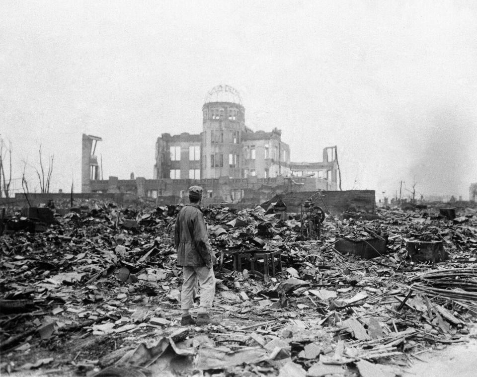 An Allied correspondent stands in the rubble in front of the shell of a building that once was a movie theater in Hiroshima, Japan, on Sept. 8, 1945, a month after the first atomic bomb ever used in warfare was dropped by the U.S.