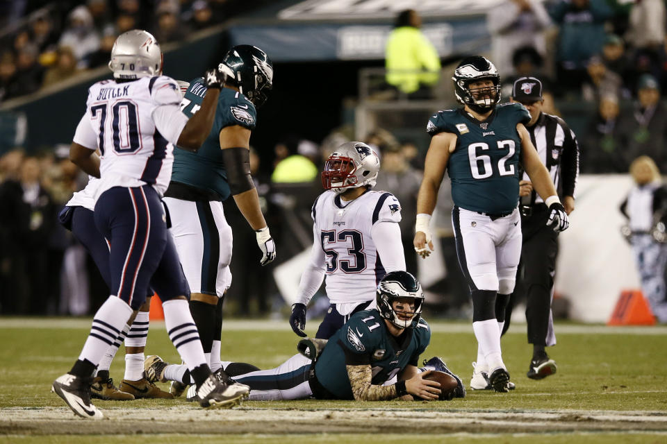 Philadelphia Eagles' Carson Wentz (11) lies on the field after being tackled by New England Patriots' Kyle Van Noy (53) during the first half of an NFL football game, Sunday, Nov. 17, 2019, in Philadelphia. (AP Photo/Michael Perez)