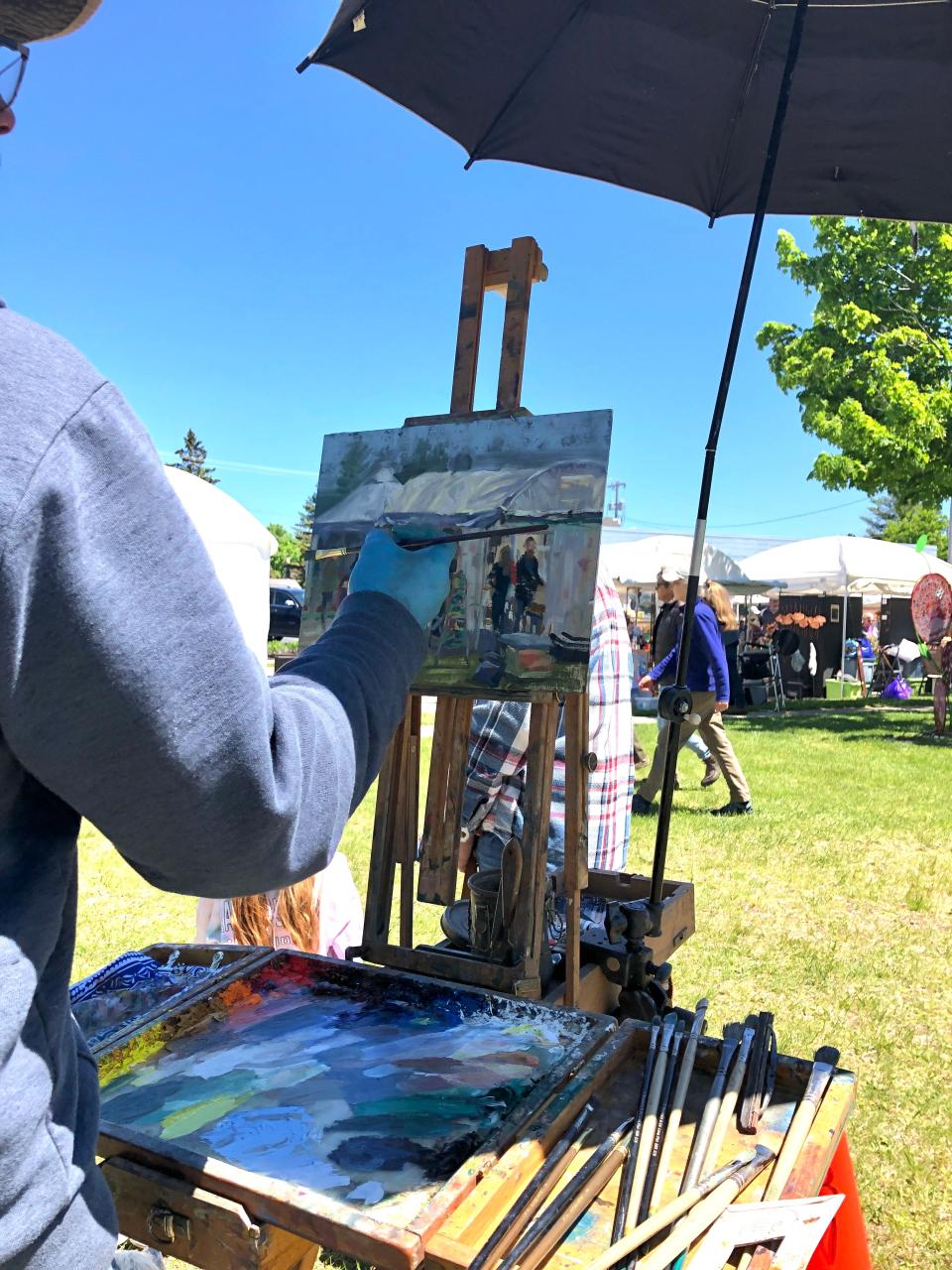 An artist at last year's Sturgeon Bay Fine Art Fair paints the scene in front of them at Martin Park. The juried art fair returns this Memorial Day weekend.