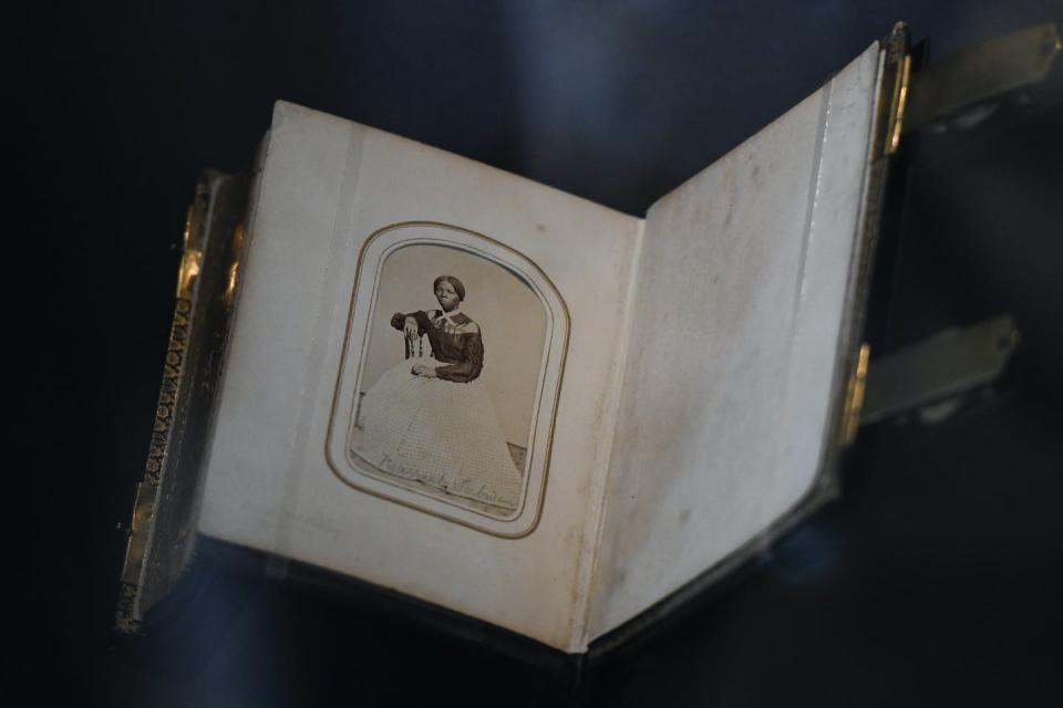 A portrait of Harriet Tubman is shown in a photo book.