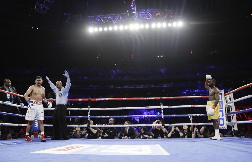 The referee stops the fight during the sixth round when England's Amir Khan could not continue after a low blow by Terence Crawfordin a WBO world welterweight championship boxing match Sunday, April 21, 2019, in New York. Crawford won the fight. (AP Photo/Frank Franklin II)