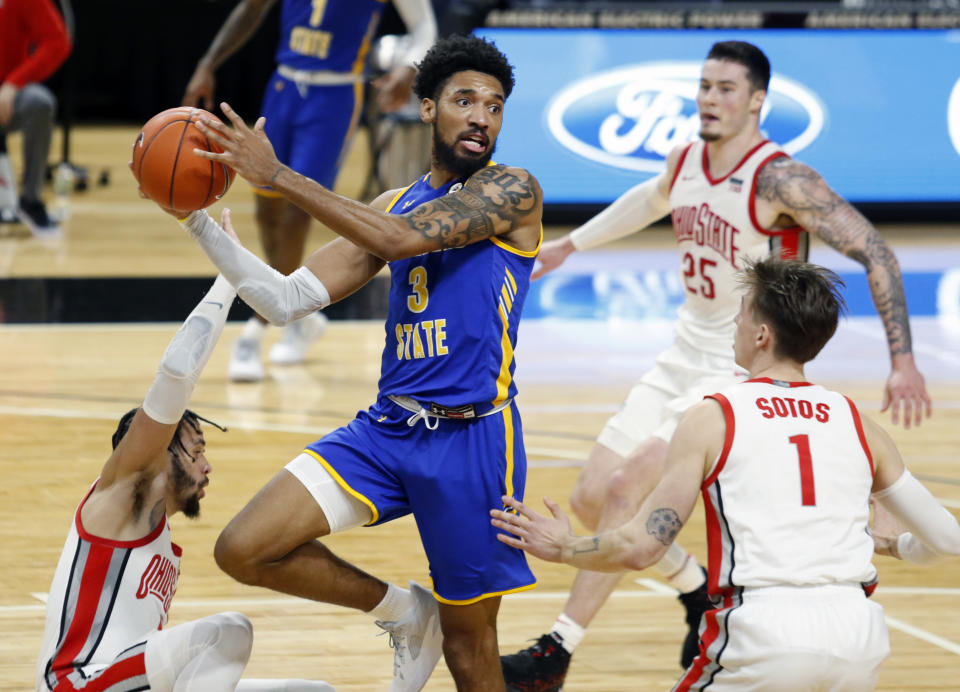 Morehead State forward James Baker (3) looks to pass between Ohio State guard Duane Washington (4), forward Kyle Young (25) and guard Jimmy Sotos (1) during the first half of an NCAA college basketball game in Columbus, Ohio, Wednesday, Dec. 2, 2020. (AP Photo/Paul Vernon)