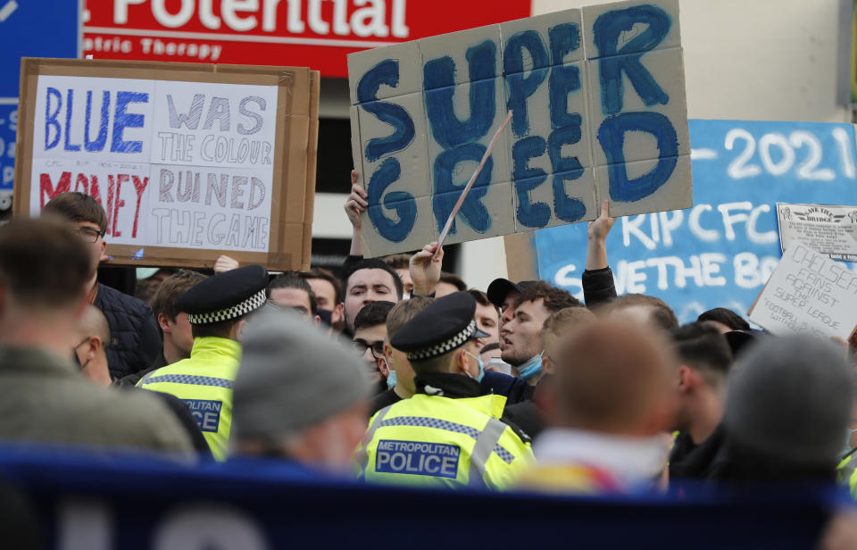 Chelsea fans protest against Chelsea's decision to be included amongst the clubs attempting to form a new European Super League before the English Premier League soccer match between Chelsea and Brighton and Hove Albion outside Stamford Bridge stadium in London, Tuesday, April 20, 2021. (AP Photo/Frank Augstein, Pool)