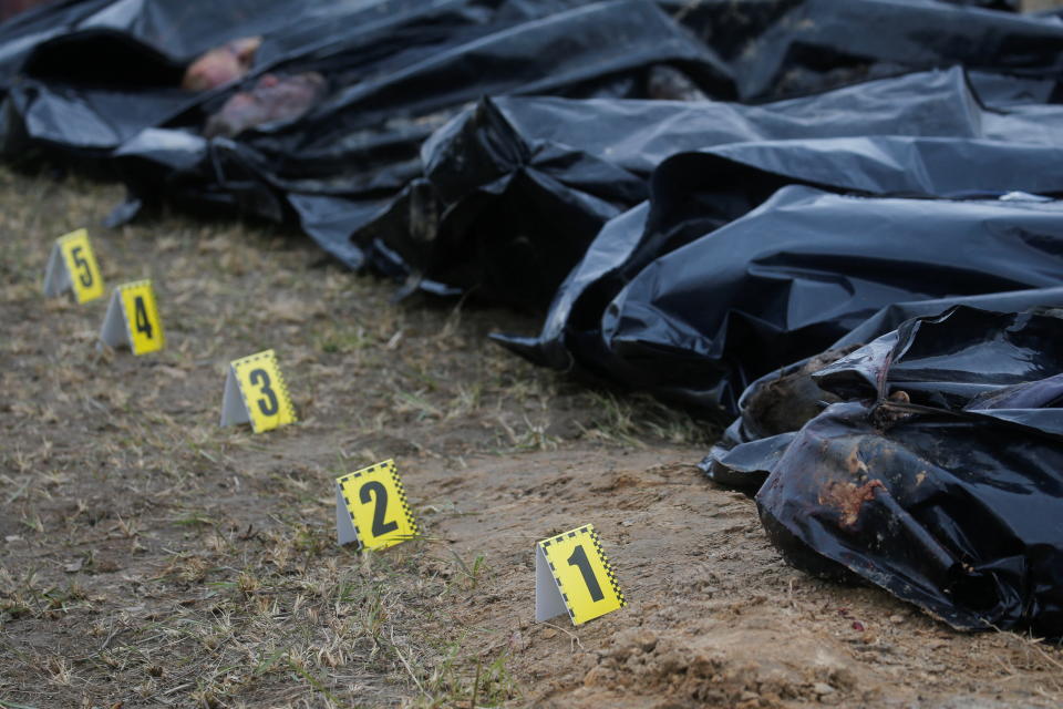 A view shows the bodies of civilians who Ukrainian officials say were killed during Russia's invasion and then exhumed from a mass grave in the town of Bucha.  Source: Reuters/Valentyn Ogirenko