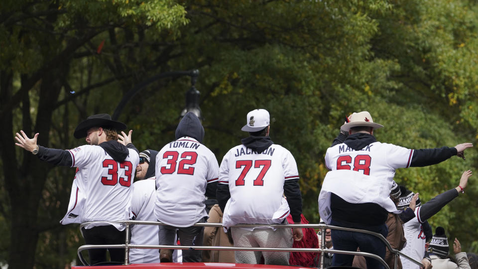 Atlanta Braves players celebrate the team's victory during a victory parade, Friday, Nov. 5, 2021, in Atlanta. The Braves beat the Houston Astros 7-0 in Game 6 on Tuesday to win their first World Series baseball title in 26 years. (AP Photo/Brynn Anderson)