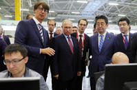 Japanese Prime Minister Shinzo Abe, second right, and Russian President Vladimir Putin, center, visit the Mazda Sollers Manufacturing Rus auto plant at the Eastern Economic Forum in Vladivostok, Russia, Monday, Sept. 10, 2018. (Mikhail Klimentyev, Sputnik, Kremlin Pool Photo via AP)