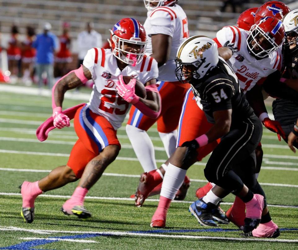 Duncanville running back Caden Durham (29) escapes Mansfield defensive tackle Tim Kelly (54) to put up six in the first half of a UIL high school football game at Vernon Newsom Stadium in Mansfield, Texas, Thursday, Oct. 12, 2023.