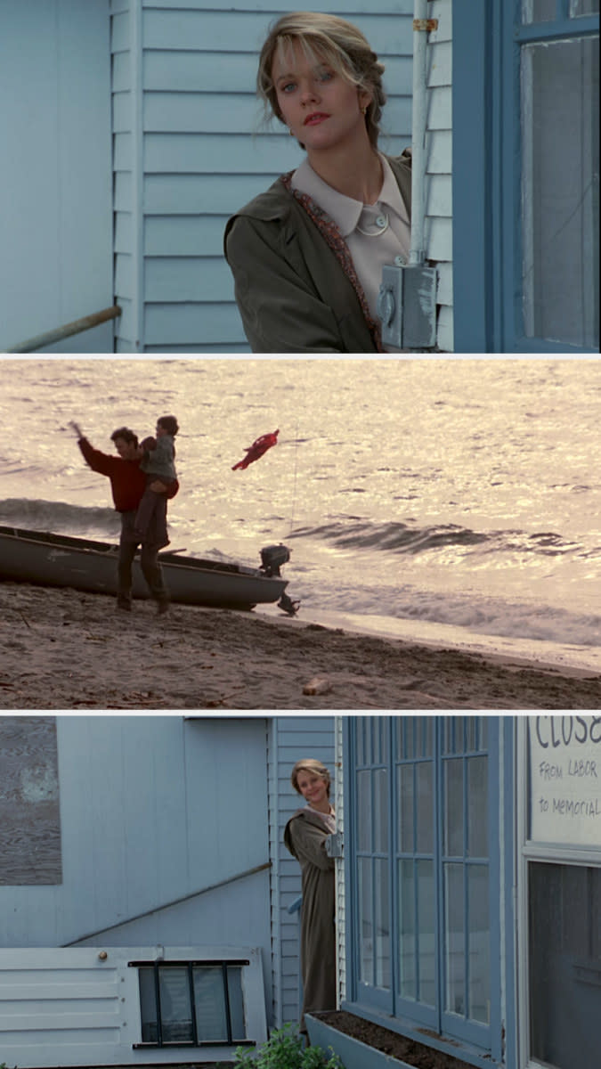 woman looking on at a son and dad playing on the beach