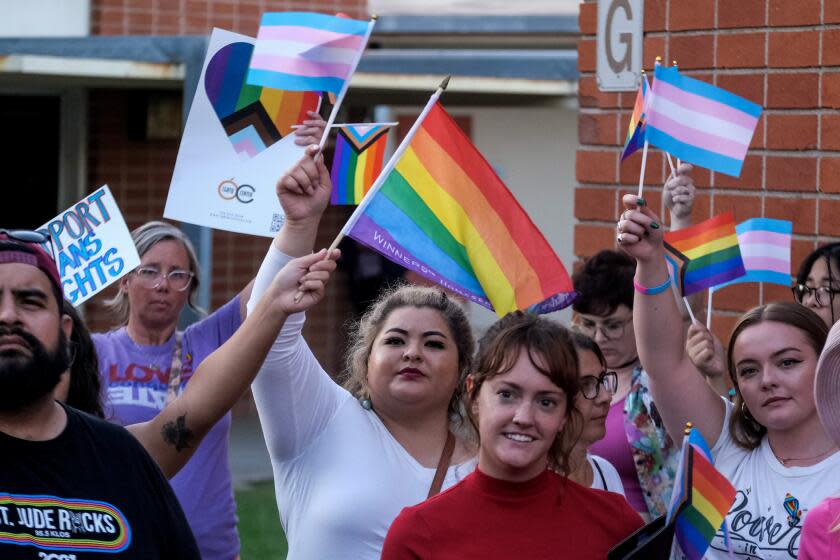 ORANGE CA SEPTEMBER 9, 2023 - People against the transgender notification policy protest outside the Orange Unified School District board meeting, Thursday, September 7, 2023 in Orange, California. The Orange Unified School District board will consider a policy Thursday that would require parental notification is their children change their gender identification or pronouns at school. (Photo by Ringo Chiu / For The Times)