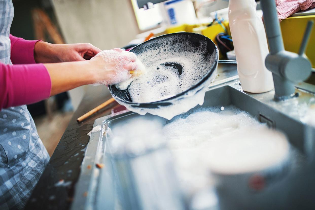 hands washing dishes at home