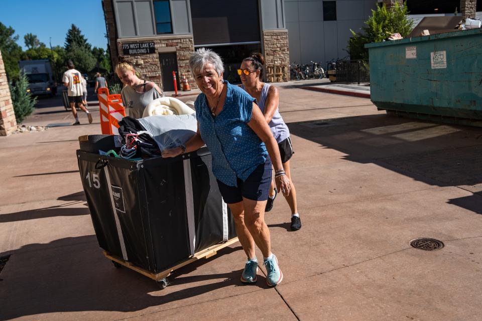 Family members help students move into the Stadium Apartments on the Colorado State campus on Aug. 14, 2023, in Fort Collins. Monday was the first day of a move-in period that runs through Wednesday.
