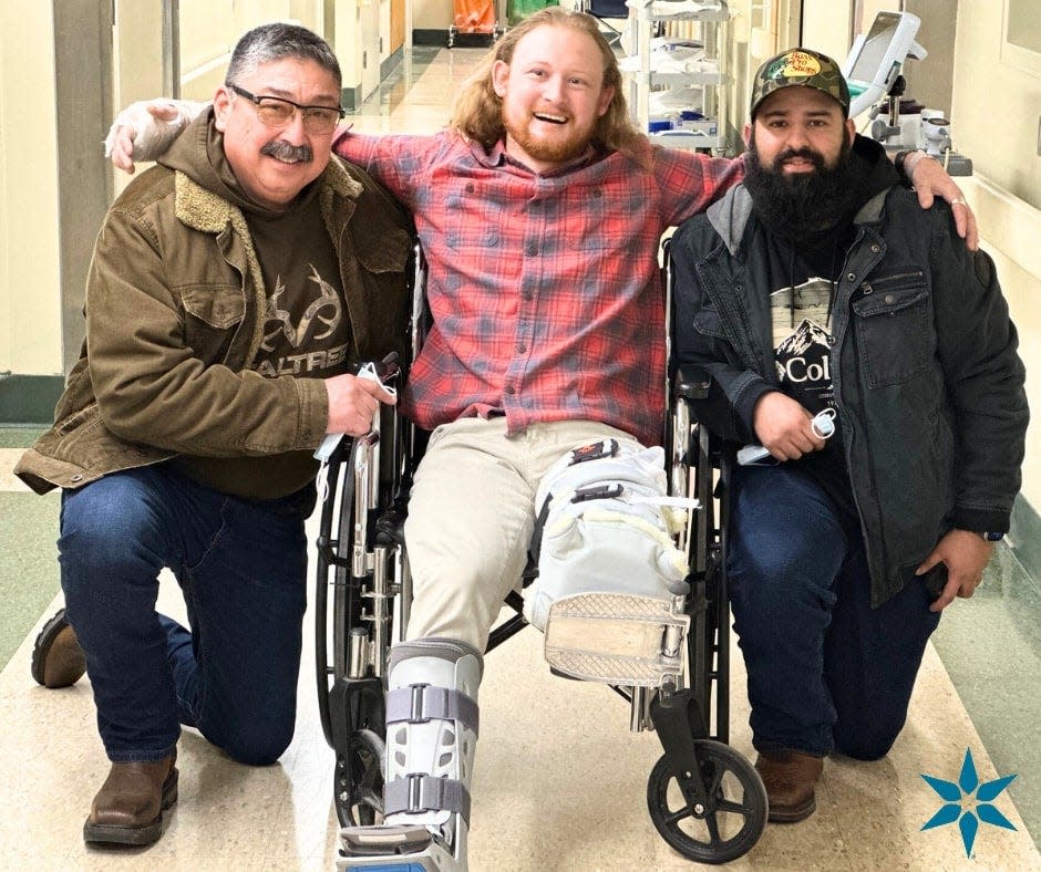 From left, Mario Garcia, Matt Reum and Nivardo De La Torre are pictured at Memorial Hospital weeks after the two men found Reum pinned in his truck beneath a bridge on Interstate 94.
