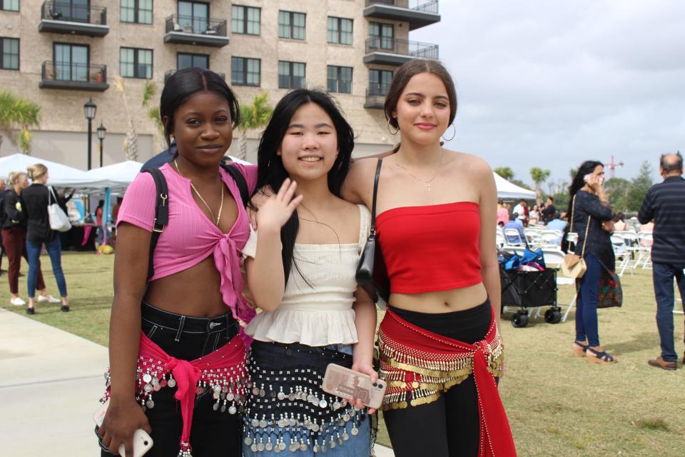 Aisha (right), Salwa Brannen's daughter, poses with friends who are all wearing hip scarves. Savannah AAPI Festival 2022.