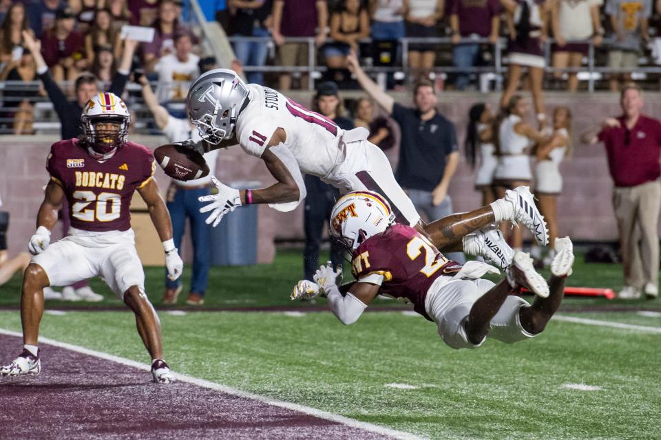 Troy wide receiver Deshon Stoudemire dives into the end zone for a touchdown during the Trojans' 31-13 win over Texas State on Saturday night at Bobcat Stadium.