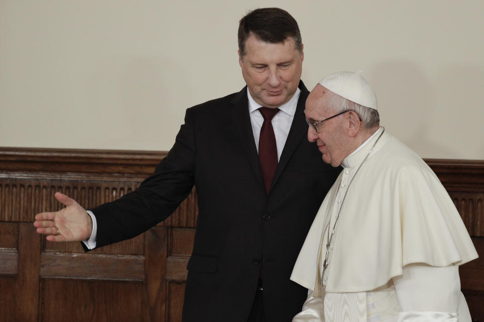 Latvian President Raimonds Vejonis, left, indicates the way to Pope Francis as they arrive at the presidential palace, in Riga, Latvia, Monday, Sept. 24, 2018. Francis has travelled to the Baltic nation of Latvia to recognize its suffering under Soviet and Nazi occupation and encourage the Christian faith that endured. (AP Photo/Andrew Medichini)