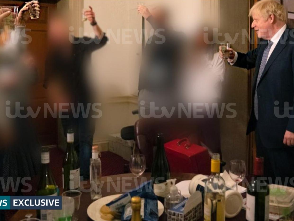 Boris Johnson raising a glass at a party thrown during one of England's lockdowns
