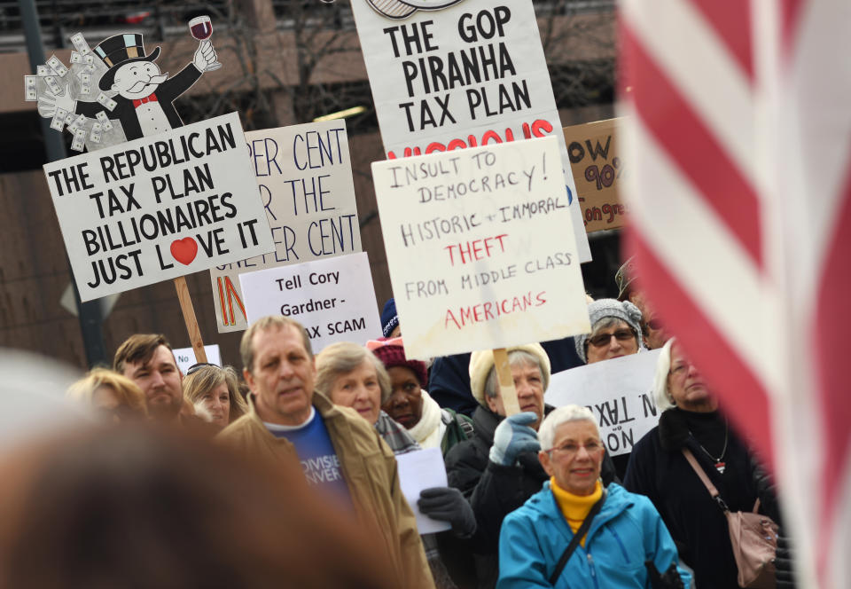 <p>Around a hundred people protested, outside U.S. Sen. Cory Gardner’s Denver office, against a tax bill in the U.S. Senate on Nov. 28, 2017 in Denver, Colo. (Photo: R.J. Sangosti/The Denver Post via Getty Images) </p>