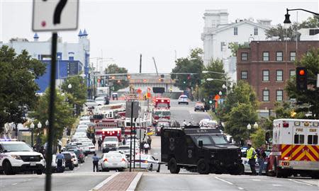 Police block off the M Street, SE, as they respond to a shooting at the Washington Navy Yard in Washington, September 16, 2013. REUTERS/Joshua Roberts