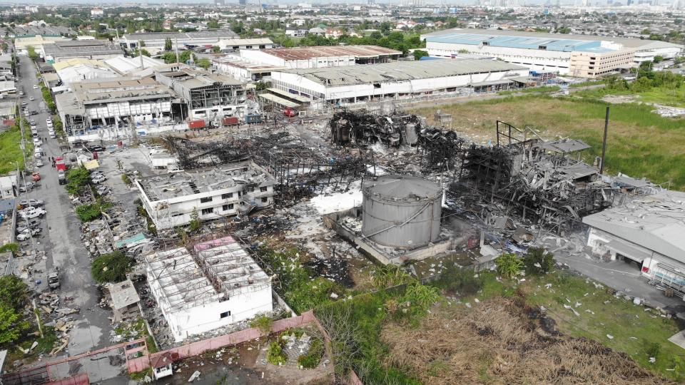 In this drone aerial photo provided by the Disaster Response Associations Thailand, twisted metal frames are all that remains of a burnt chemical factory Tuesday, July 6, 2021, in Samut Prakan, Thailand. Firefighters finally extinguished a blaze at a chemical factory just outside the Thai capital early Tuesday, more than 24-hours after it started with an explosion that damaged nearby homes and then let off a clouds of toxic smoke that prompted a widespread evacuation. (Disaster Response Associations Thailand via AP)