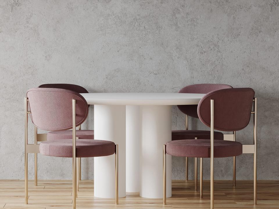 Meeting room or dining area with large white round table and pink chairs.