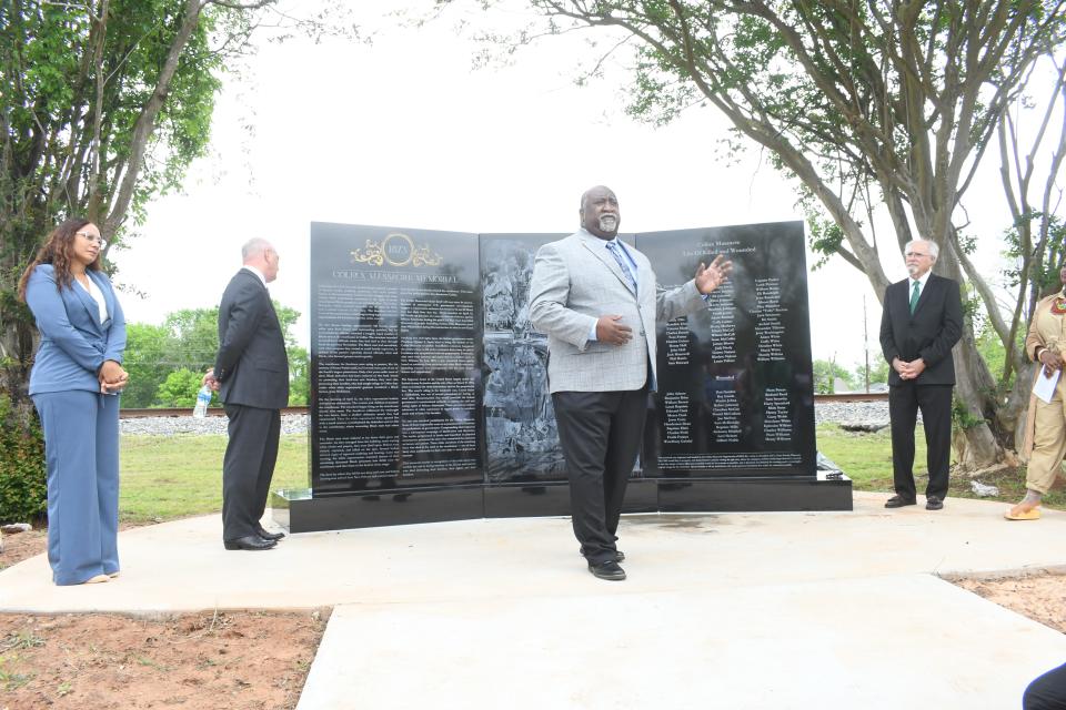 Mandi MItchell (far left), Gov. John Bel Edwards (second from left), the Rev. Avery Hamilton (front) and Dean Woods (far right) unveil the Colfax Massacre Memorial monument Thursday. The memorial seeks to correct the historical account of what happened on April 13, 1873 in which 60-80 Black men were slain by a white mob.