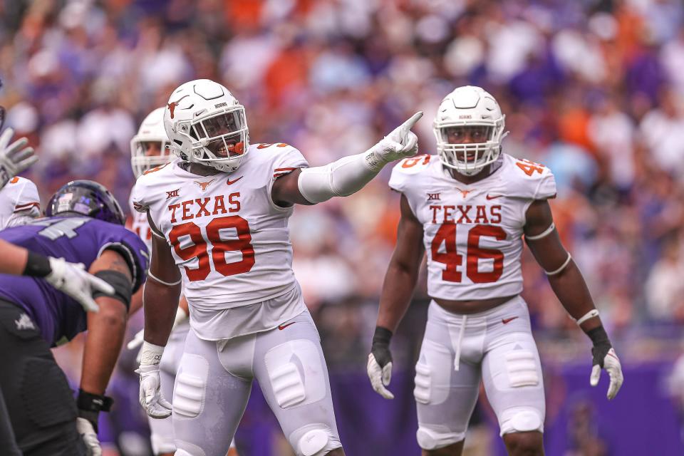 Defensive lineman Moro Ojomo, left, was chosen by Philadelphia in the seventh round of the NFL draft Saturday. "We can't believe you're here in the seventh round," Eagles general manager Howie Roseman told him on the draft day phone call.