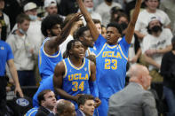UCLA guards David Singleton, left, and Peyton Watson celebrate the team's impending win in an NCAA college basketball game against Colorado on Saturday, Jan. 22, 2022, in Boulder, Colo. UCLA won 71-65. (AP Photo/David Zalubowski)