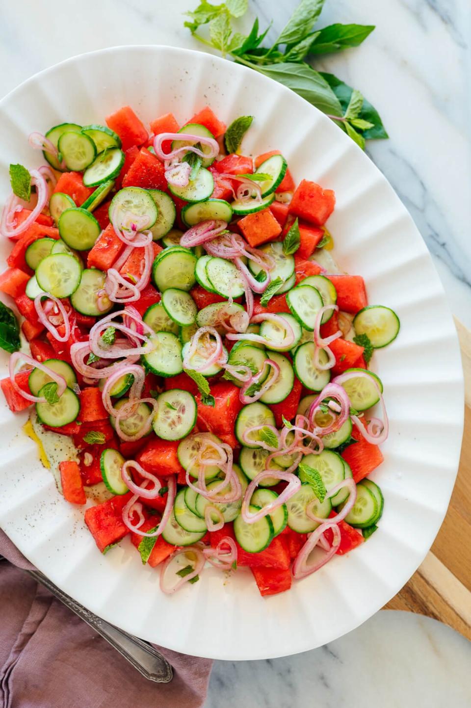 <p>Watermelon is delicious on its own, but this recipe proves it’s possibly even better when combined with creamy yogurt sauce, cucumbers, shallots, basil, and mint.</p> <p>Get the recipe <a href="https://cookieandkate.com/herbed-watermelon-salad-recipe/" rel="nofollow noopener" target="_blank" data-ylk="slk:here;elm:context_link;itc:0;sec:content-canvas" class="link ">here</a>.</p>