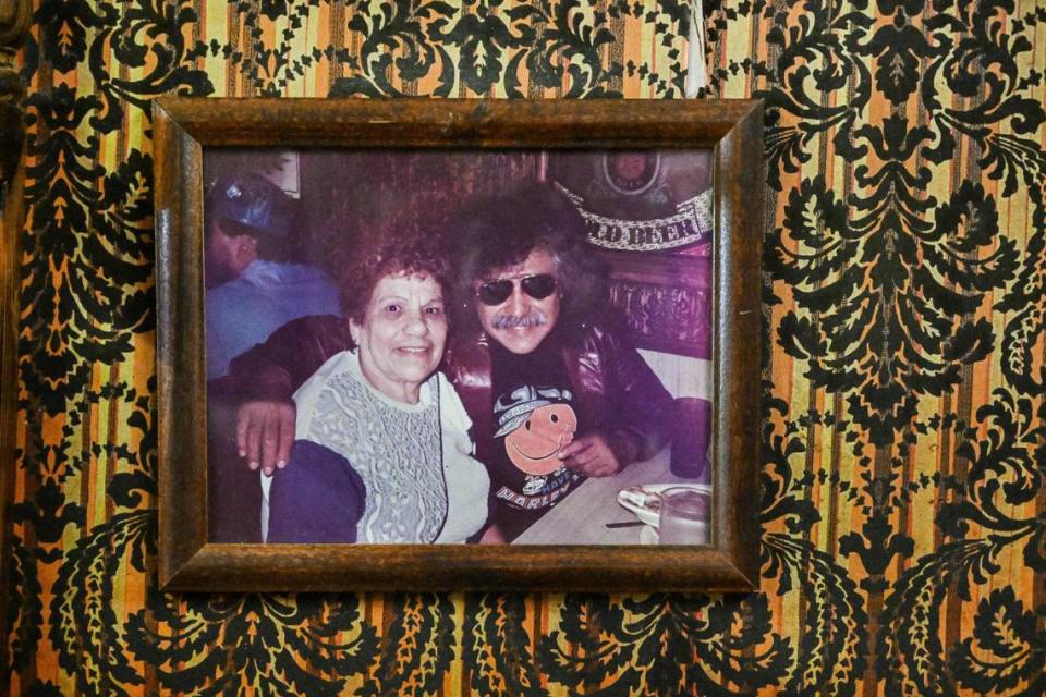Refugia Salcido, known as Cuca, is seen in a photo with musician Freddy Fender on the wall adorned with its original wallpaper at Cuca’s Mexican restaurant in Chinatown. Cuca opened the restaurant 50 years ago and has passed it down to her granddaughter, Margaret Sifuentes. She still runs it and her daughter Gina Daniels, who runs the Tower District location.