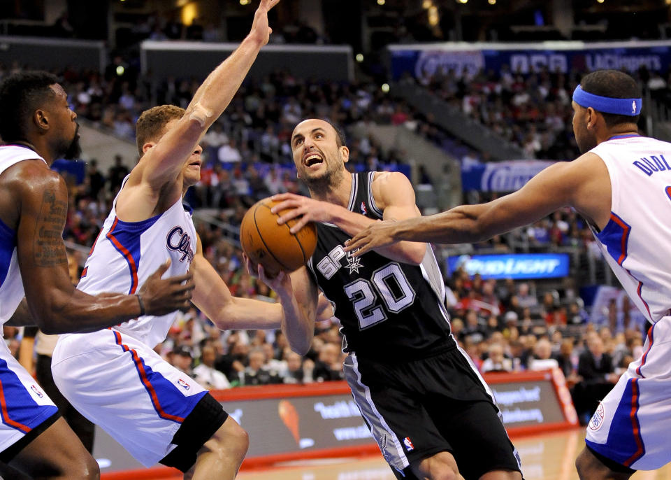 San Antonio Spurs guard Manu Ginobili (20), of Argentina, drives on Los Angeles Clippers forward Blake Griffin. left center, center DeAndre Jordan, left, and forward Jared Dudle, right, as he goes to the basket in the first half of a NBA basketball game, Tuesday, Feb. 18, 2014, in Los Angeles.(AP Photo/Gus Ruelas)