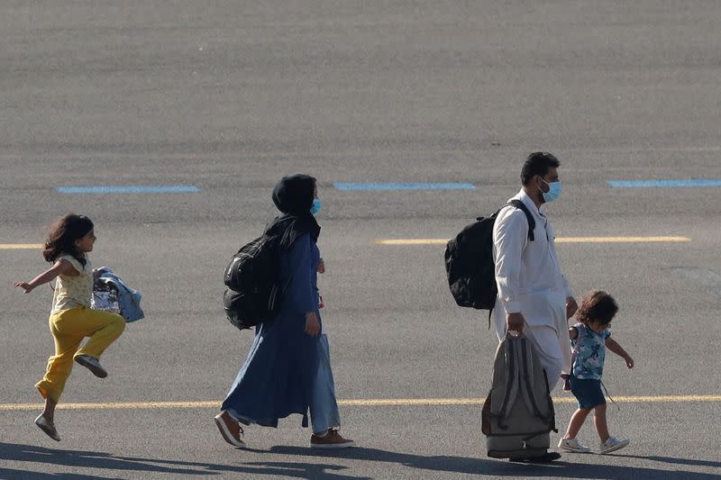 People who have been evacuated from Afghanistan arrive at Melsbroek military airport