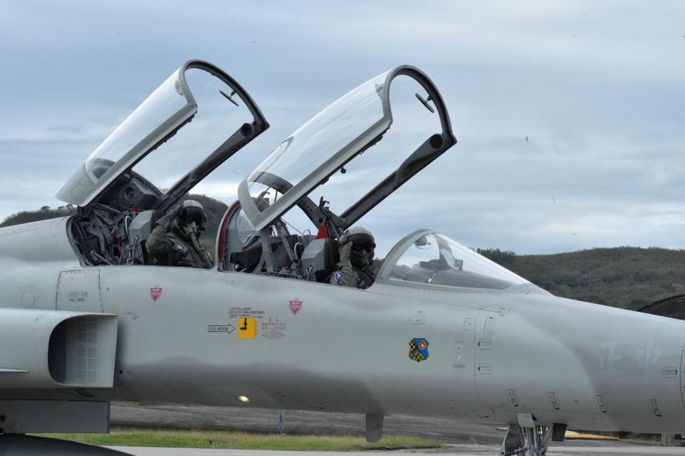 Pilots salute from a ROCAF F-5F during an annual drill at Chihhang Air Base, southeast Taiwan on January 30, 2018. <em>Photo credit should read MANDY CHENG/AFP via Getty Images</em>