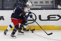 Columbus Blue Jackets' Boone Jenner, left, and Tampa Bay Lightning's Erik Cernak chase the puck during the second period of an NHL hockey game Thursday, Jan. 21, 2021, in Columbus, Ohio. (AP Photo/Jay LaPrete)