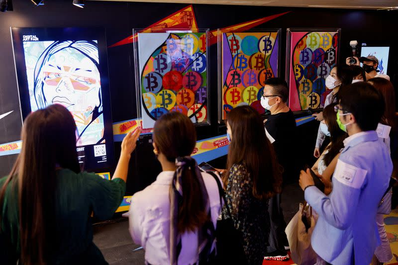 FILE PHOTO: Visitors walk in front of an artwork which will be converted into NFT and auctioned online at Sotheby's, in Hong Kong