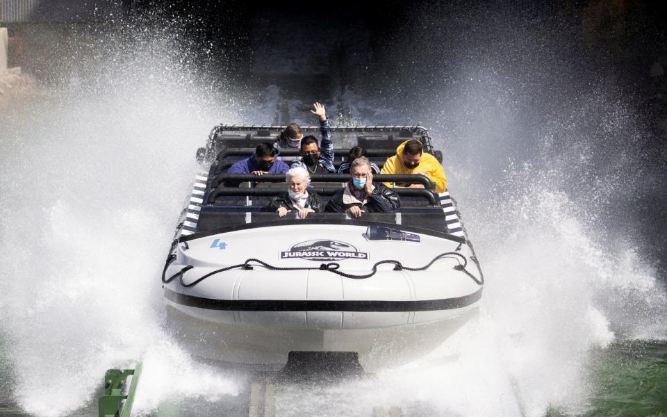 Guests react while riding "Jurassic World: The Ride" on reopening day of Universal Studios Hollywood during the outbreak of the coronavirus disease, in Universal City - Mario Anzuoni/REUTERS