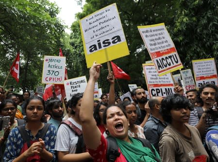 A woman shouts slogans during a protest against the scrapping of the special constitutional status for Kashmir by the government, in New Delhi