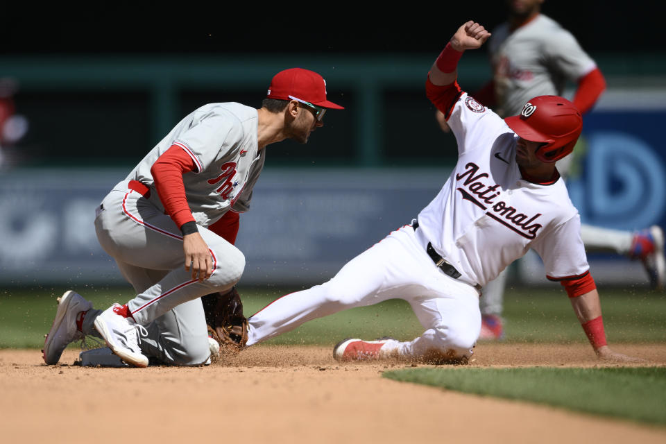 Washington Nationals' Lane Thomas is safe stealing second base against Philadelphia Phillies shortstop Trea Turner, left, during the inning of a baseball game, Sunday, April 7, 2024, in Washington. Thomas advanced to third as the ball got by Turner. (AP Photo/Nick Wass)