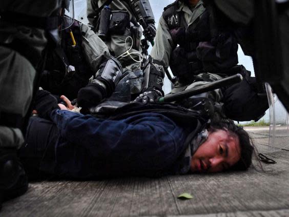 Riot police detain a protester at Kowloon Bay in Hong Kong (AFP/Getty)