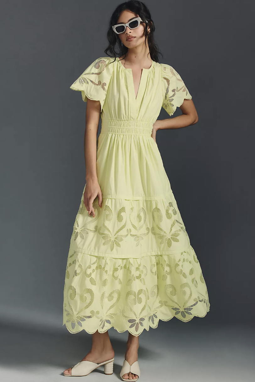 brunette model wearing white heel sandals and light green The Somerset Maxi Dress: Cutwork Edition in green (photo via Anthropologie)