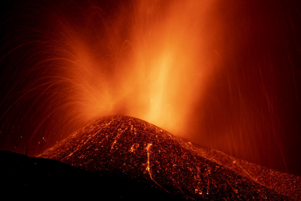 Lava from a volcano eruption flows on the island of La Palma in the Canaries, Spain, Thursday, Sept. 23, 2021. A volcano on a small Spanish island in the Atlantic Ocean erupted on Sunday, forcing the evacuation of thousands of people. Experts say the volcanic eruption and its aftermath on a Spanish island could last for up to 84 days. (AP Photo/Emilio Morenatti)