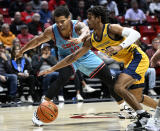 San Diego State guard Matt Bradley (20) and UC Irvine guard DJ Davis (22) vie for the ball during the first half of an NCAA college basketball game Tuesday, Nov. 29, 2022, in San Diego. (AP Photo/Denis Poroy)