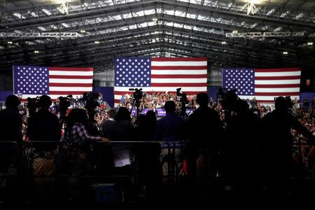 Members of the news media cover U.S. President Donald Trump speaking at a Make America Great Again Rally in Washington, Michigan April 28, 2018. REUTERS/Joshua Roberts/Files