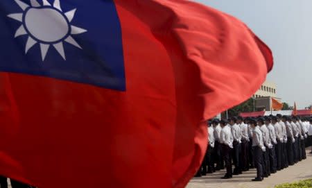 FILE PHOTO: Members of the National Security Bureau take part in a drill next to a national flag at its headquarters in Taipei, Taiwan, November 13, 2015. REUTERS/Pichi Chuang