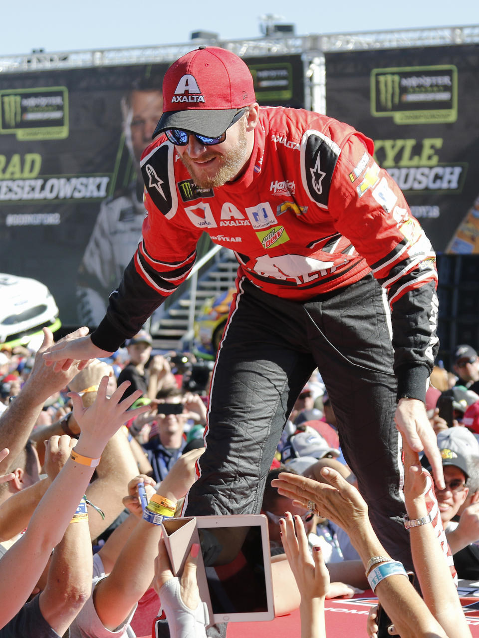 FILE - In this Nov. 19, 2017, file photo, Dale Earnhardt Jr. interacts with fans during driver introductions before a NASCAR Cup Series auto race at Homestead-Miami Speedway in Homestead, Fla. Dale Earnhardt Jr. is returning to the track Saturday, June 13, 2020, getting behind the wheel for an Xfinity race at Homestead-Miami Speedway -- the place where his Cup Series career ended three years ago. (AP Photo/Terry Renna, File)