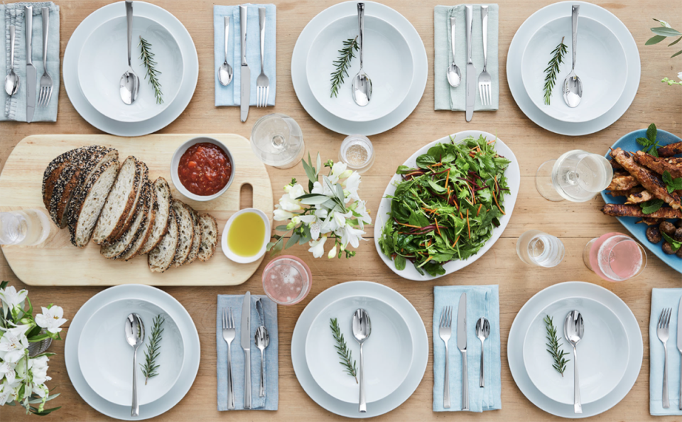 Tableware set out on table with food