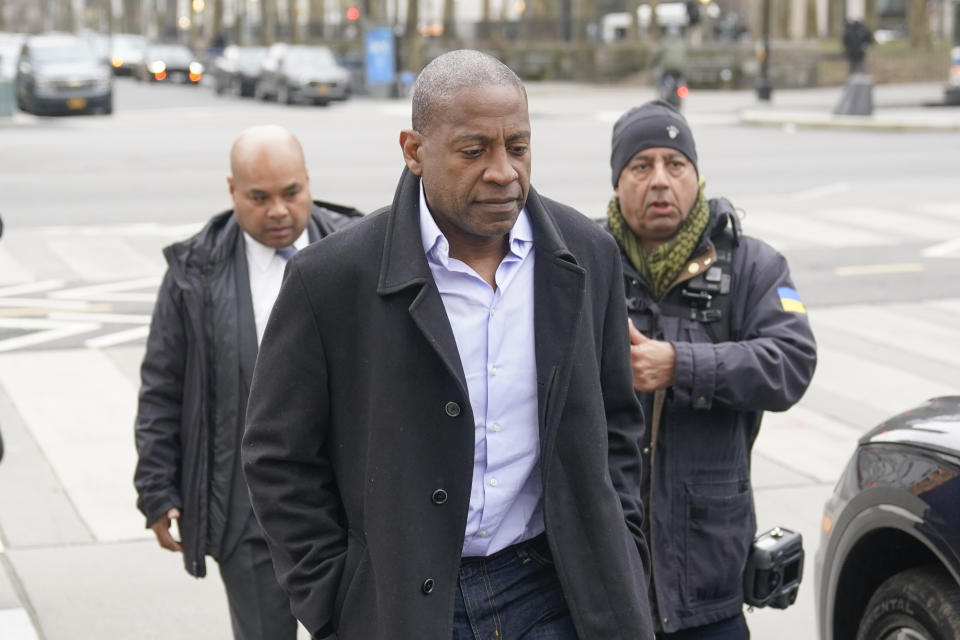 Carlos Watson, center, leaves Brooklyn federal court in New York, Thursday, Feb. 23, 2023. The founder of the troubled digital start-up Ozy Media has been arrested on fraud charges as part of what prosecutors say was a scheme to prop up the financially struggling company. (AP Photo/Seth Wenig)