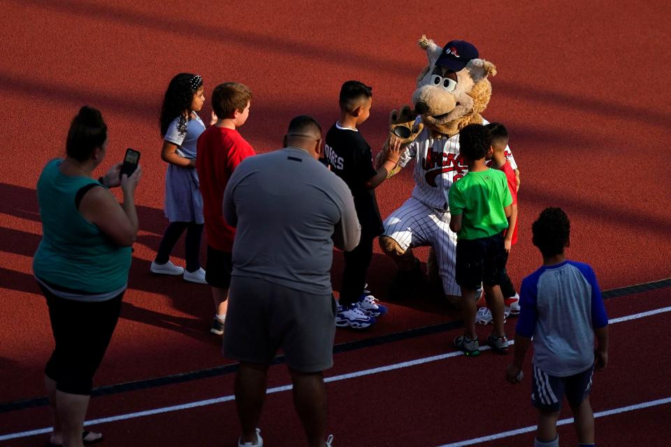The New Jersey Jackal mascot meets children during the team's first game at Hinchliffe Stadium in Paterson on Sunday, May 21, 2023.