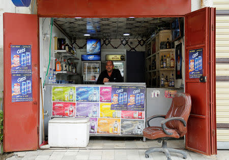 A man sells liquor in his shop, after it was banned during the Islamic State militants' seizure of the city, in Mosul, Iraq April 18, 2019. REUTERS/Abdullah Rashid