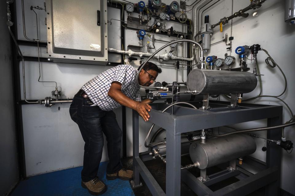An officer checks part of a hydrogen plant at Oil India Limited in Jorhat, India, Thursday, Aug. 17, 2023. Green hydrogen is being touted around the world as a clean energy solution to take the carbon out of high-emitting sectors like transport and industrial manufacturing. (AP Photo/Anupam Nath)